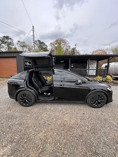 Tesla Model X with falcon-wing doors open at the True South shop
